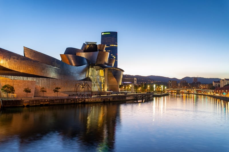 The Guggenheim Museum in Bilbao light up at dusk, an icon of modern architecture