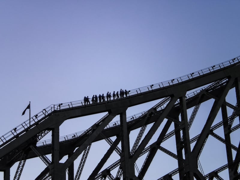 Group of people climbing the Story Bridge in Queensland.