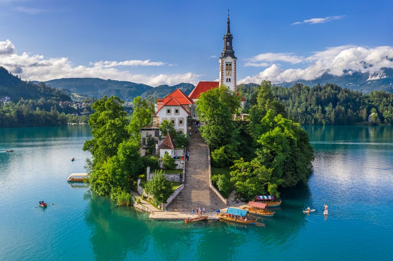 Old cathedral on a tiny island on an emerald green lake in Slovenia, the most underrated European destination for travel in 2023