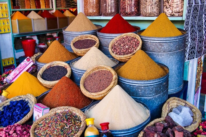 Bowls of colful grains, spices and nuts on display in Souks of Marakesh, one of the best markets in the world