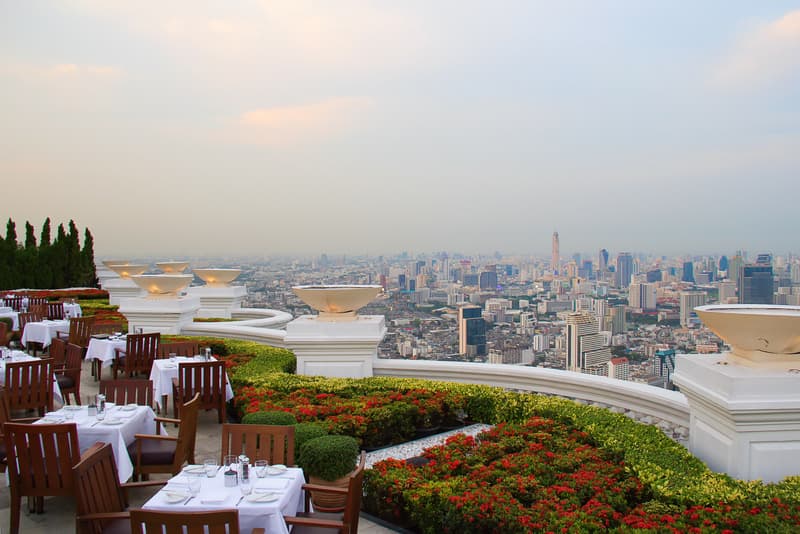Luxury restaurant on high-rise balcony overlooking Bangkok, culinary capital of southeast Asia