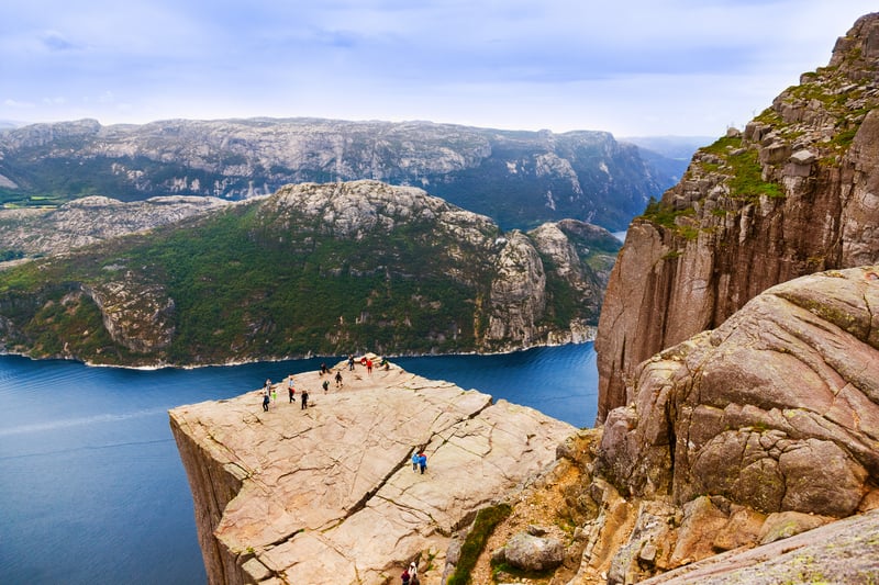 Hikers at Pulpit Rock in fjord Lysefjord - Norway, one of the most scenic day treks in the world