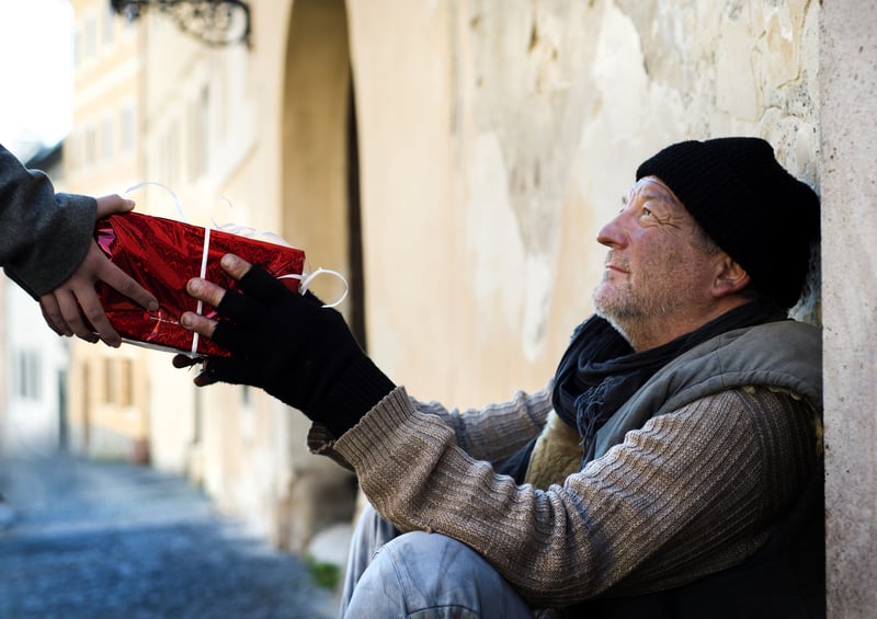 Global citizenship can mean helping those in need, a person giving to a homeless man-1