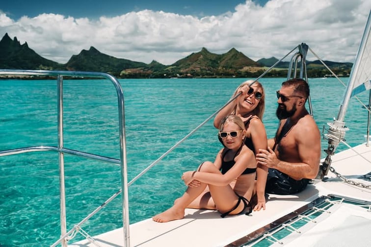Family living on a Yacht on a coral reef in the Indian Ocean