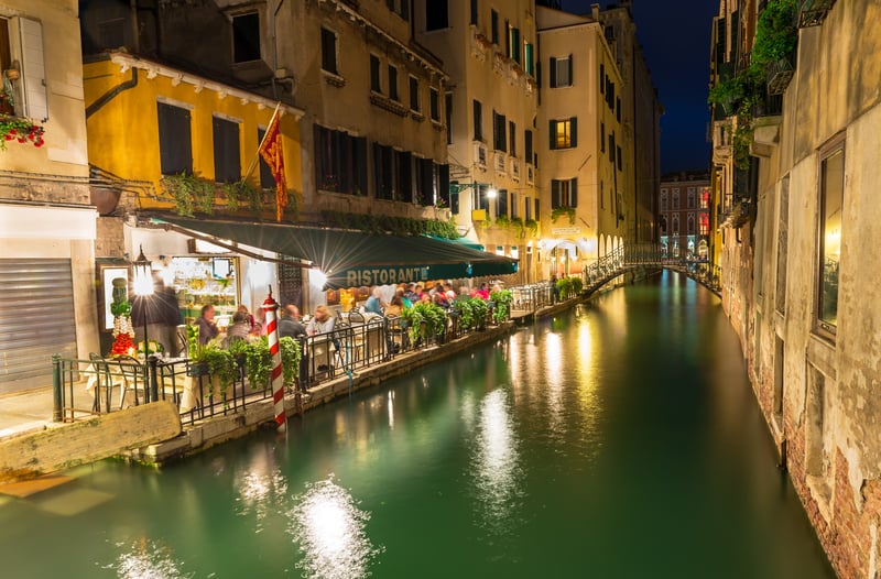 Night view of canal and restaurant in Venice, a perfect fine ding luxury travel experience