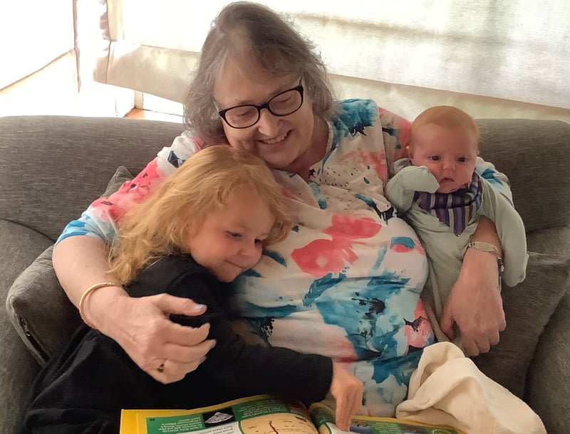 Grandmother hugging two granddaughters