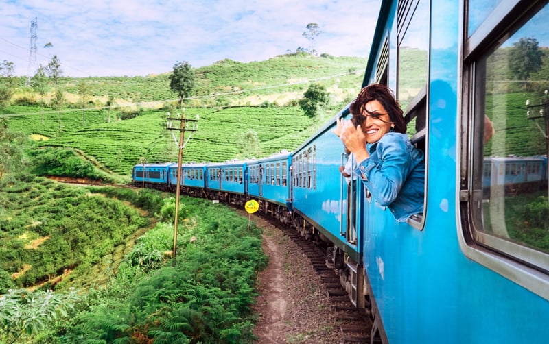 Traveler enjoying as she embarks on the world's great railway journeys between ports and coast to coast.