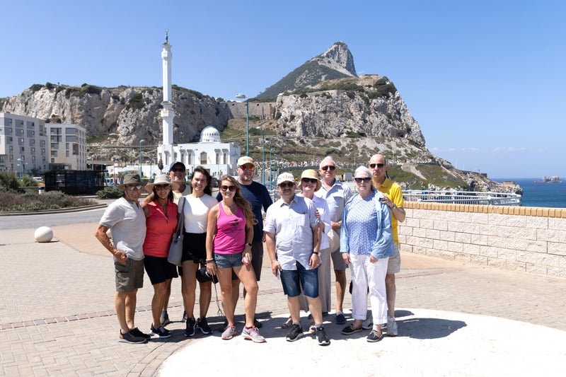 What to do in Gibraltar? This group found out, standing on the harbor foreshore with the famous Rock of Gibraltar in the background 