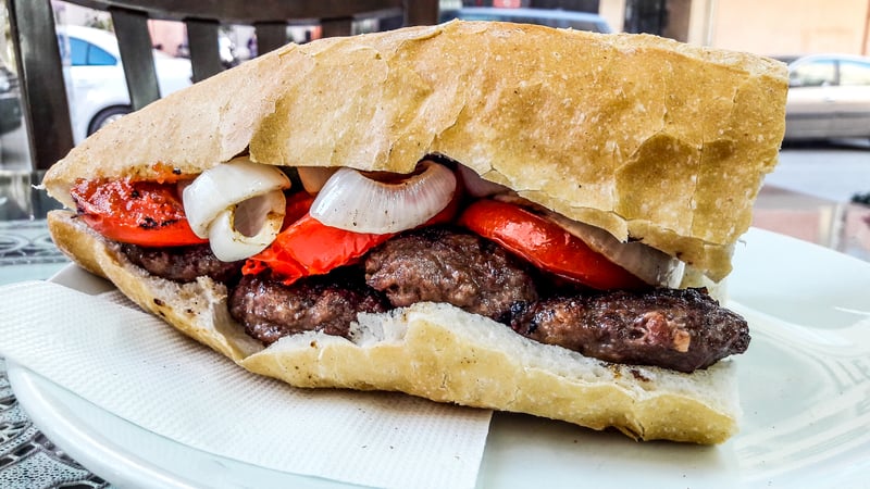 Turkish Kofte Ekmek / Meatball Sandwich with tomatoes, onion and green pepper. Traditional Fast Food and Turkey's most popular street food dish