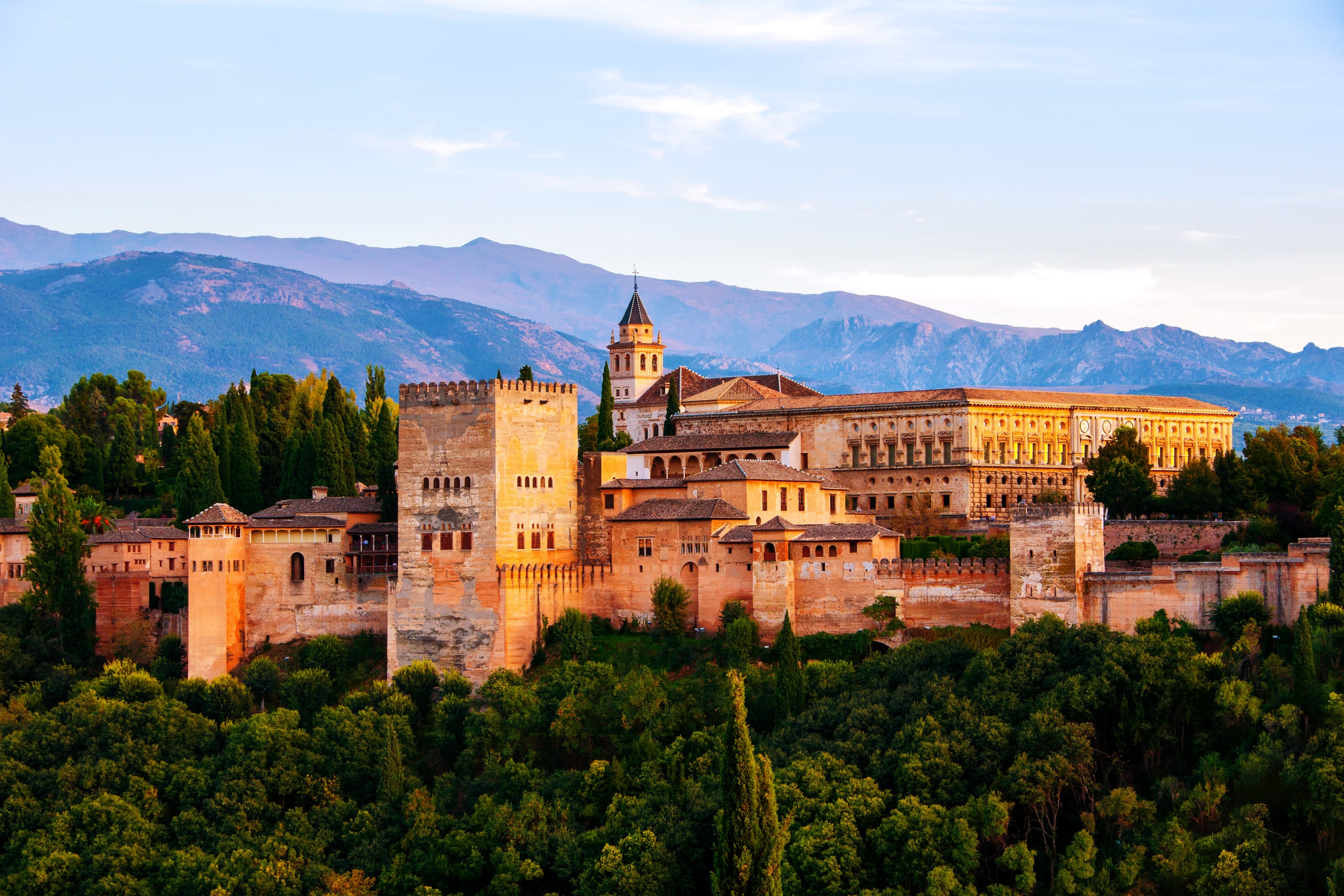 The ancient fortress Alhambra surrounded by forest in Granada, Spain