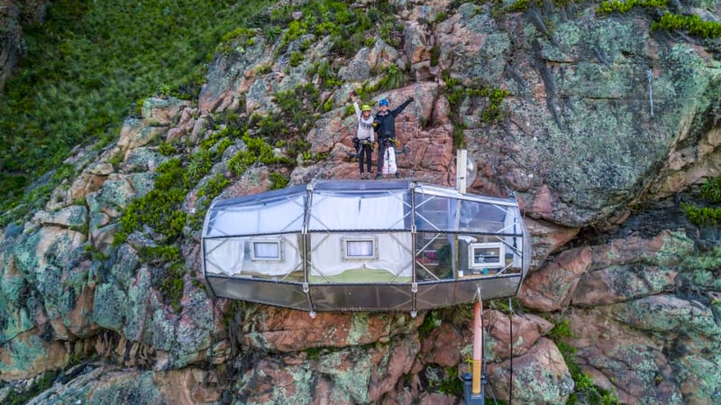 A couple on top of their room in Skylodge Adventure Suites, Peru