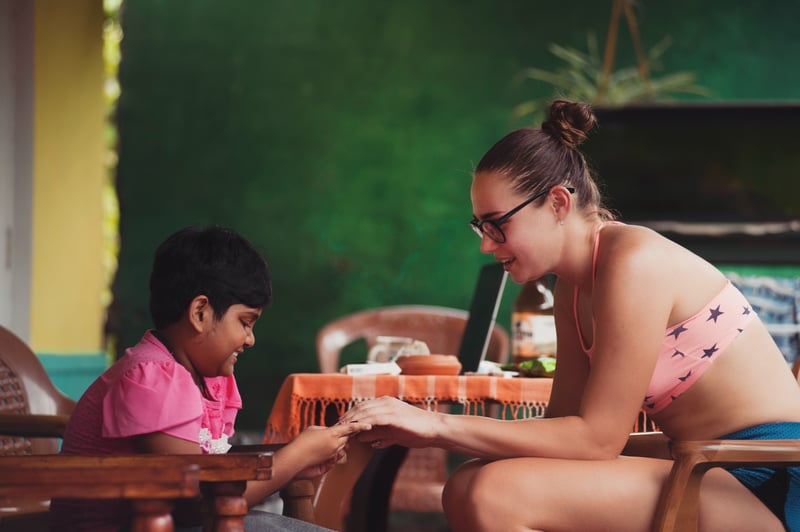 Young woman teaching a kid in Sri Lanka
