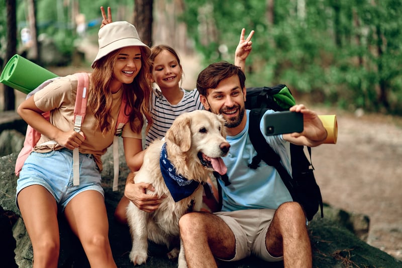 World schooling family posing for photo with their traveling dog