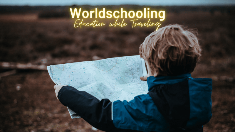 Boy holding map and title saying worldschooling Education while traveling