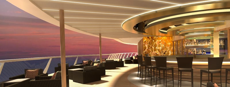 Outdoor dining and bar overlooking the water at sunset on condo ship MV Narrative