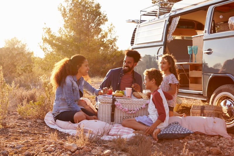 Family having a picnic on a road trip around the world with kids